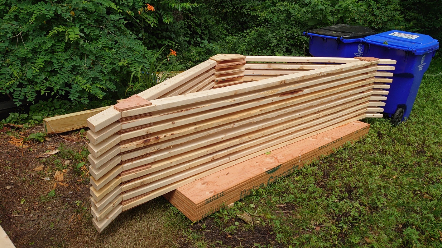 A stack of finished roof trusses